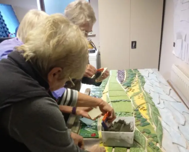 People working on the mosaic