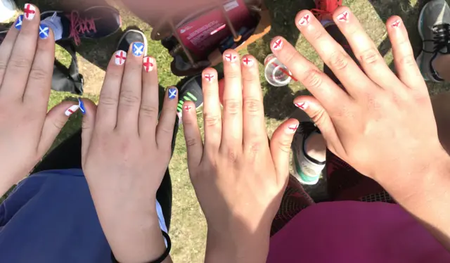 Fans paint their nails with England and Scotland flags