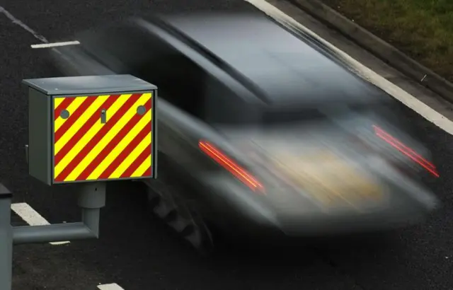 A car zooming past a speed camera