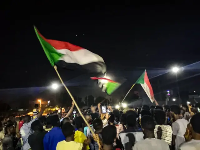 Sudanese demonstrators wave national flags as they protest in the streets of the capital Khartoum to demand civilian rule on July 15, 2019.