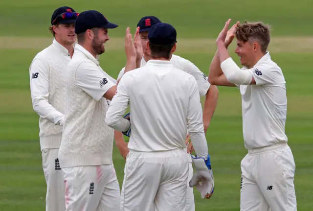 Sam Curran is congratulated by his England Lions team-mates