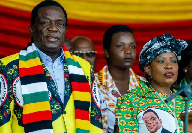 Emmerson Mnangagwa (L), Zimbabwe's President and presidential candidate for the ZANU PF party, flanked by his wife Auxilia Mnangagwa (R), arrives for his last campaign rally at the National Sports Stadium in Harare, on July 28, 2018.