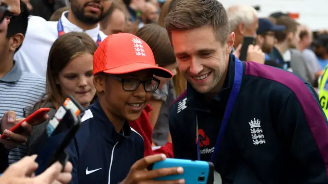 Chris Woakes with young fan