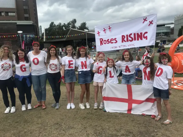 England fans with a banner saying roses rising