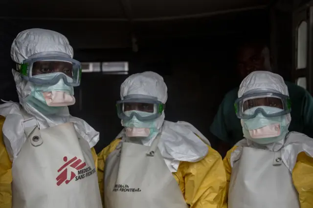 Three Ebola workers in protective clothing