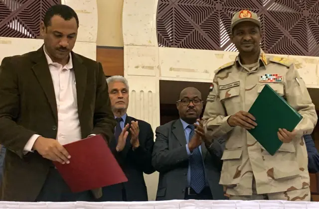 Sudan leaders applauding