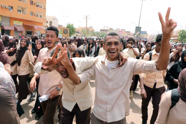 Protesters celebrate and flash victory sign on the streets of Khartoum, Sudan, 17 July 2019