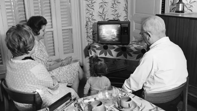 Family watching TV footage of Armstrong's first step on the Moon