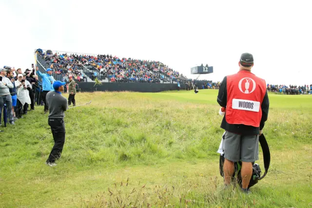 Tiger Woods chips from rough left of the 12th green