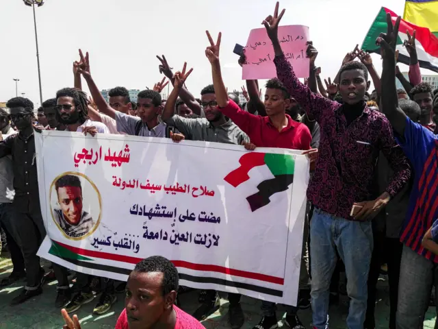 Sudanese protesters chant slogans and wave national flags as they march in the capital Khartoum"s Green Square on July 18, 2019