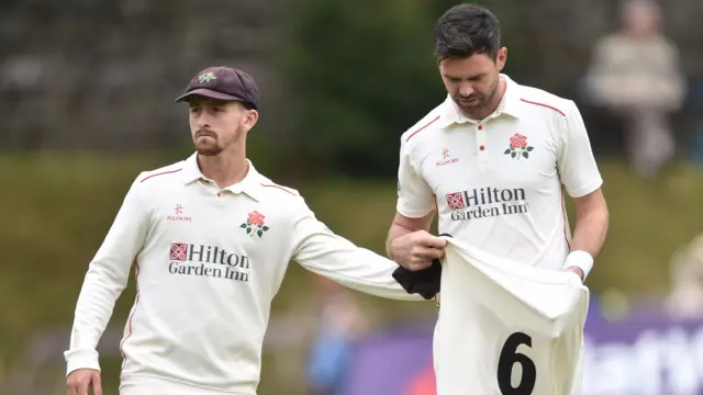 Jimmy Anderson got a consoling pat from Lancashire team-mate Josh Bohannon as he walked off in search of treatment