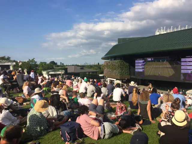 A packed Henman Hill/Murray Mound enjoys the early evening action