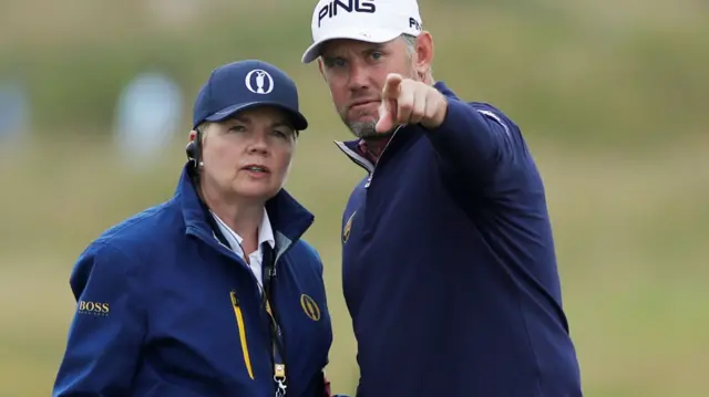 Lee Westwood consults an official on the 10th hole