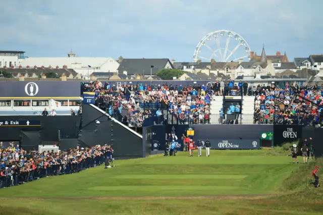 Paul Waring walks off the first tee with his caddie and marker Gary McNeill