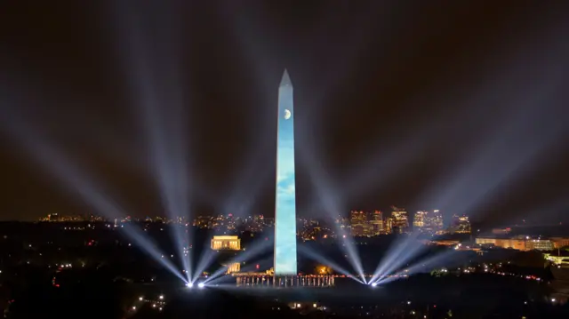 The Washington Monument, lit up with projected archive footage