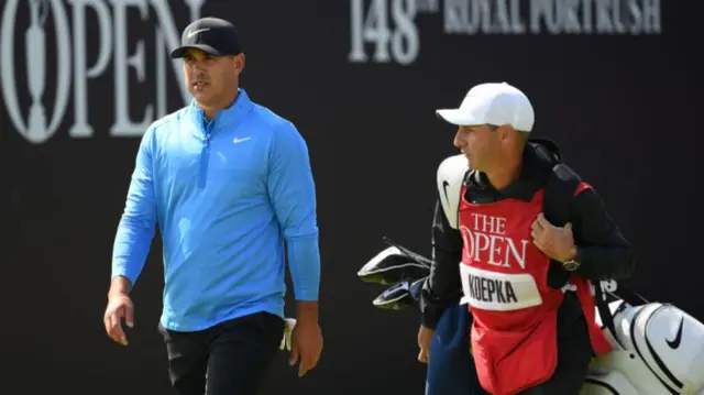 Brooks Koepka and caddie