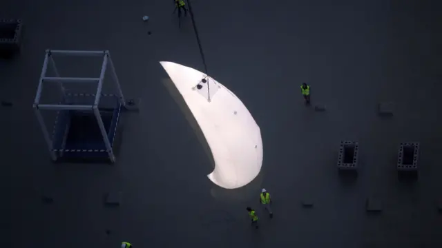 A giant Moon on a building's rooftop