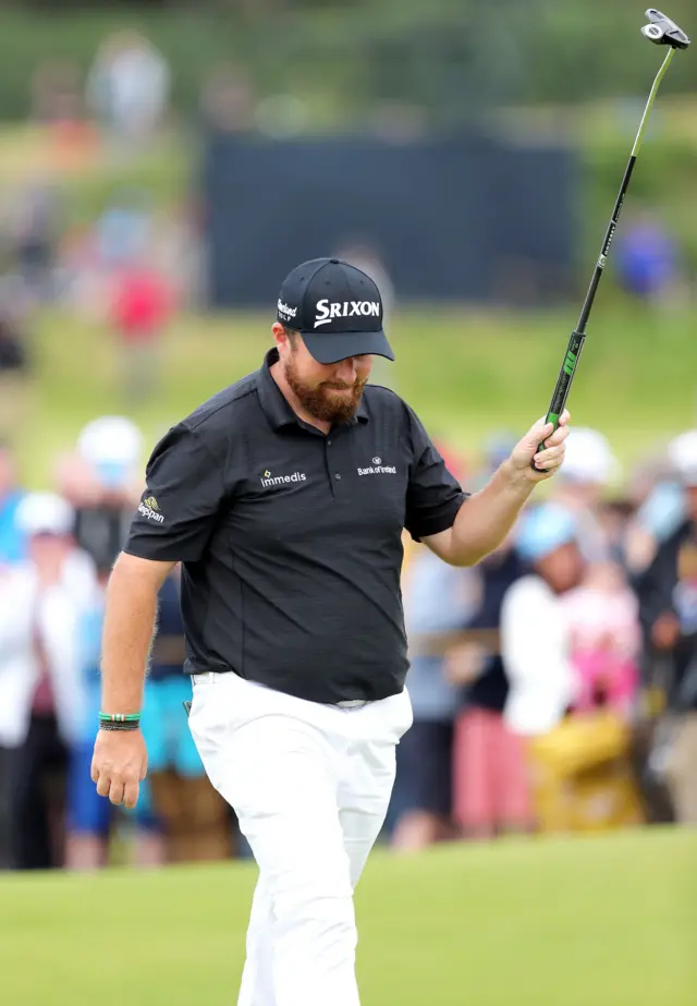 Shane Lowry celebrates a birdie on the ninth hole