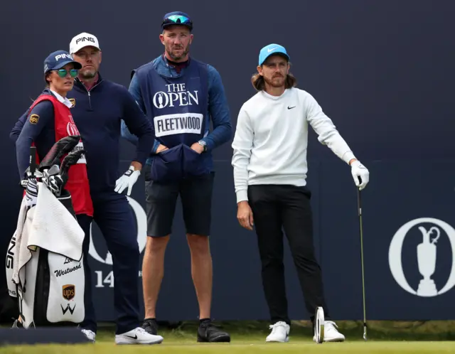 Lee Westwood and Tommy Fleetwood with their caddies on the first tee