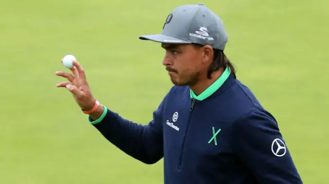 Rickie Fowler salutes the crowd on the 18th hole