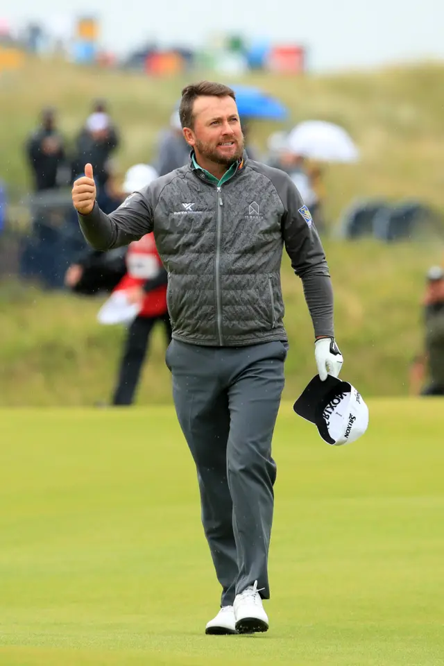 Graeme McDowell gives a thumbs up to the crowd gathered on the 18th hole