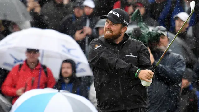 Shane Lowry hits a shot in the rain