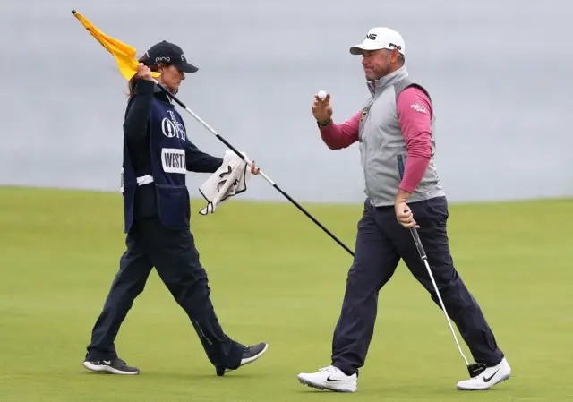 Lee Westwood celebrates after a birdie putt on the fifth hole