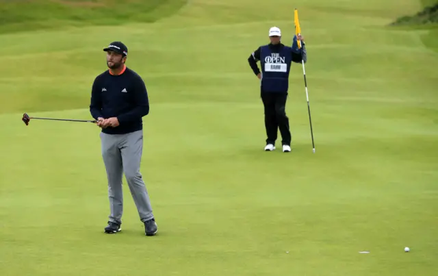 Jon Rahm reacts after missing a putt on the second hole