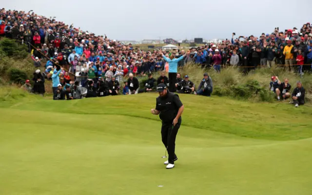 Shane Lowry celebrates his birdie putt on the fourth hole