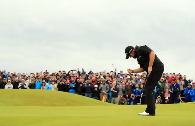 Shane Lowry and his fans celebrate sinking a putt on the 15th