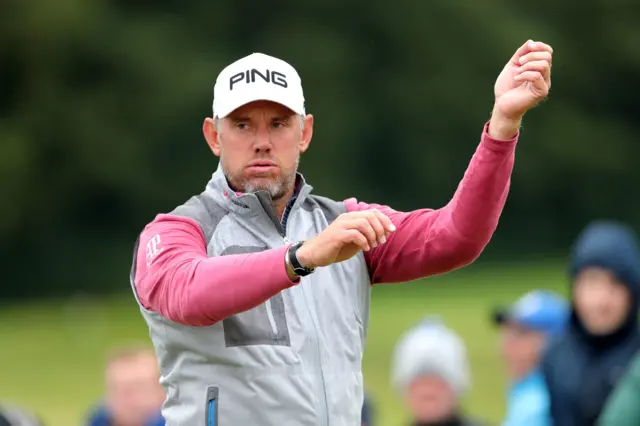 Lee Westwood throws his arms in the air in frustration