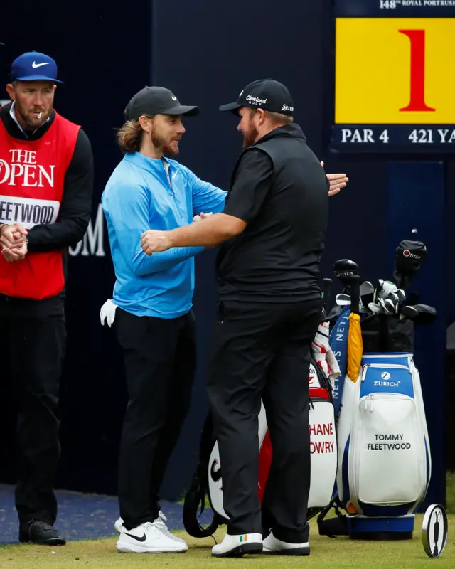 Tommy Fleetwood and Shane Lowry shake hands on the first tee