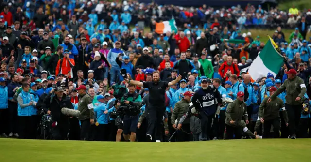 Shane Lowry walks down the 18th fairway