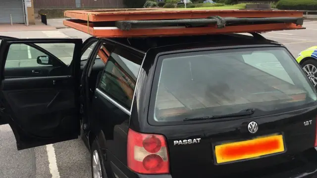 A car with a shed on the roof