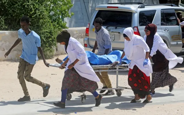 Nurses at the Medina hospital assist a civilian wounded in an explosion outside a hotel near the international airport in Mogadishu.