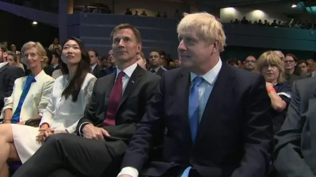 Boris Johnson sits next to Jeremy Hunt