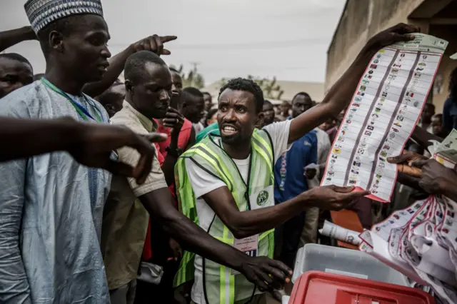 Man holding a ballot paper