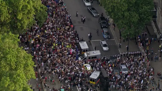 Police have formed a barrier away from the gates of Downing Street