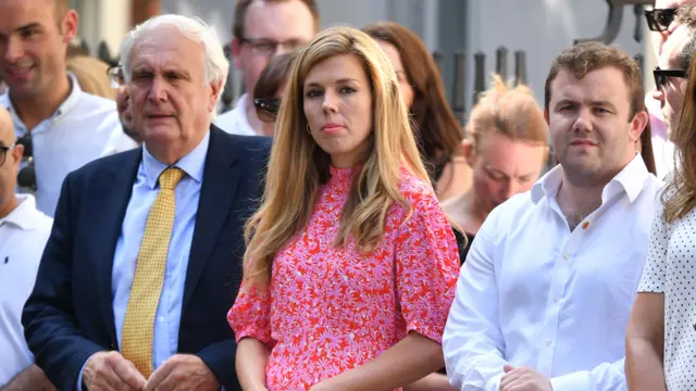 Carrie Symonds, companion of new Prime Minister Boris Johnson, waits for Mr. Johnson to speak to media outside Number 10,