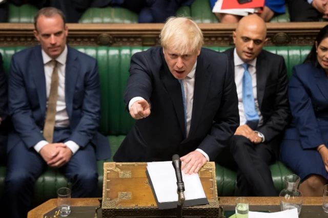 Johnson points at the Opposition front bench