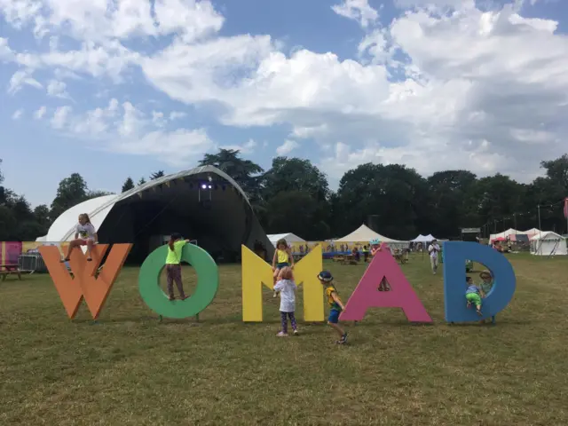 Children at Womad on sign