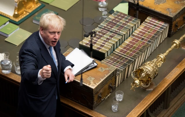 Boris Johnson turns away from the dispatch box to face the benches behind him