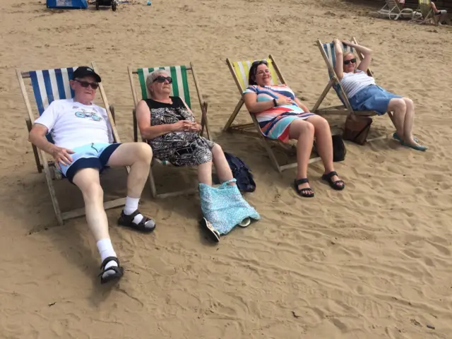 Family in deck chairs