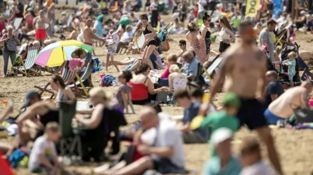 People on beach in sun