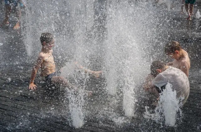 Kids in water fountains