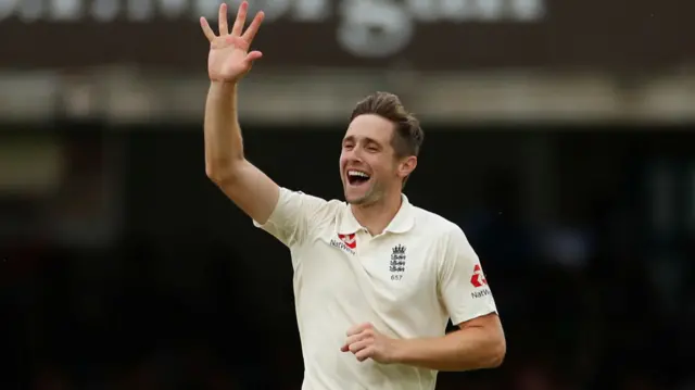 Chris Woakes celebrates after taking the wicket of Ireland"s Stuart Thompson