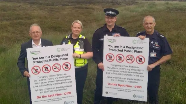 Police and councillors with the signs