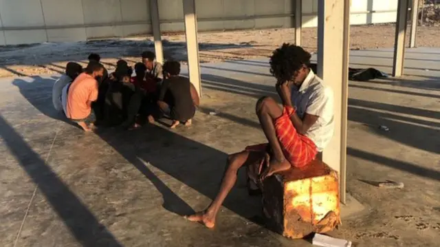 Migrants are seen rescued by Libyan coast guard after their wooden boat capsized off the coast of Komas, a town east of the capital Tripoli, Libya,