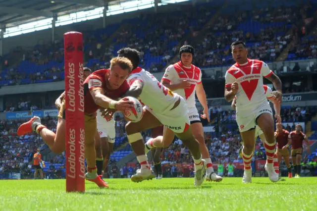 Lewis Tierney of Catalans Dragons scores their first try of the game during the Challenge Cup semi-final match between St Helens