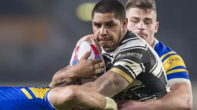 Hull FC's Albert Kelly is tackled by Leeds' Stevie Ward